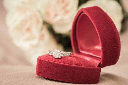 Wedding rings in a box on a brown backgroundの写真素材