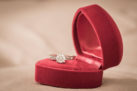 Wedding rings in a box on a brown backgroundの写真素材