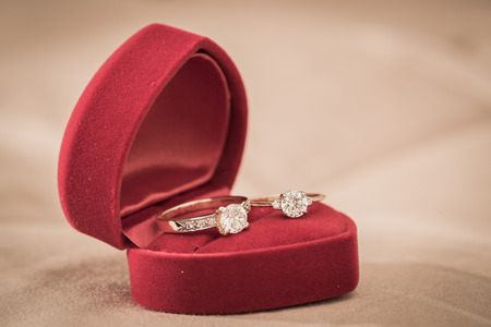 Wedding rings in a box on a brown backgroundの写真素材