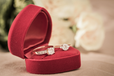 Wedding rings in a box on a brown backgroundの写真素材