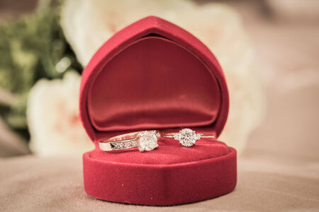 Wedding rings in a box on a brown backgroundの写真素材
