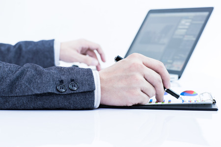 Businessman analyzing investment charts with laptop. Accountingの写真素材