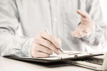Businessman analyzing investment charts with laptop. Accountingの写真素材