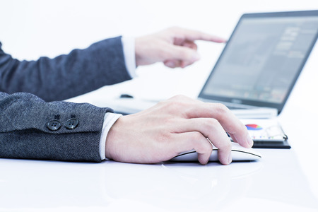 Businessman analyzing investment charts with laptop. Accountingの写真素材