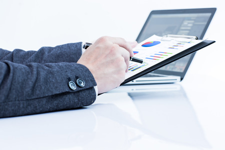 Businessman analyzing investment charts with laptop. Accountingの写真素材