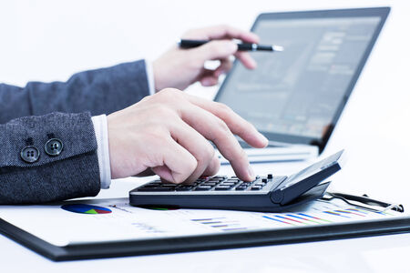 Businessman analyzing investment charts with laptop. Accountingの写真素材