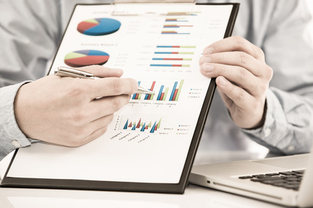 Businessman analyzing investment charts with laptop. Accountingの写真素材