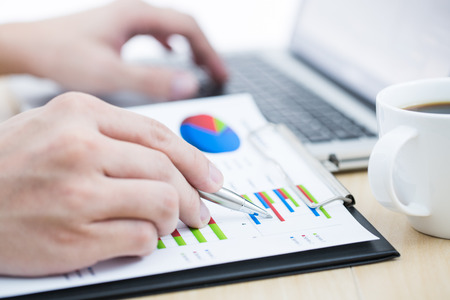 Businessman analyzing investment charts with laptop. Accountingの写真素材