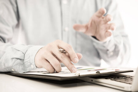 Businessman analyzing investment charts with laptop. Accountingの写真素材