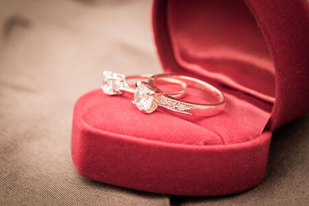Wedding rings in a box on a brown backgroundの写真素材