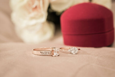 Wedding rings in a box on a brown backgroundの写真素材