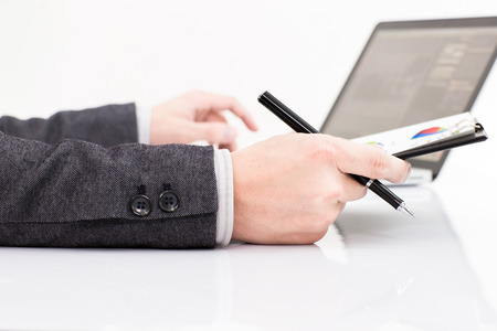 Businessman analyzing investment charts with laptop. Accountingの写真素材