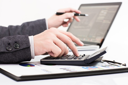 Businessman analyzing investment charts with laptop. Accountingの写真素材
