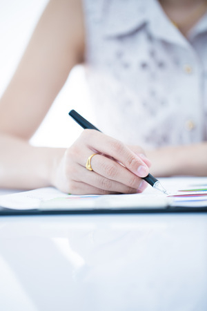 woman hand with pen and business report. Accountingの写真素材