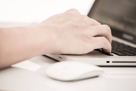 Hands of a man working with laptopの写真素材