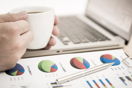 Businessman analyzing investment charts with laptop. Accountingの写真素材