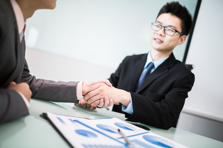 Close up of businessmen shaking handsの写真素材