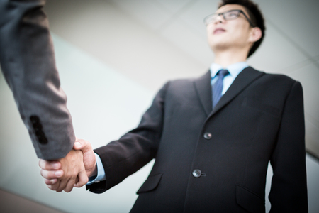Close up of businessmen shaking handsの写真素材