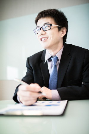 business report and man hand with pen. Accountingの写真素材