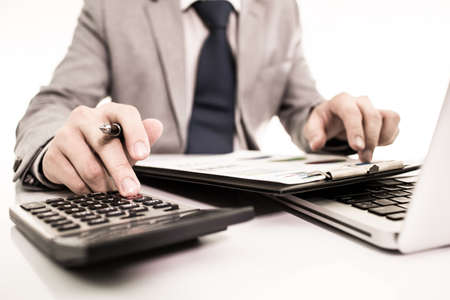 Businessman analyzing investment charts with laptop. Accountingの写真素材