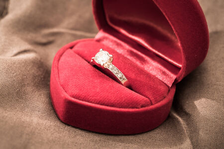 Wedding rings in a box on a brown backgroundの写真素材