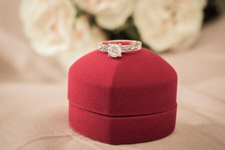 Wedding rings in a box on a brown backgroundの写真素材