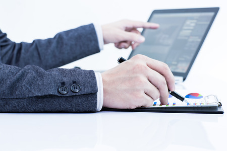 Businessman analyzing investment charts with laptop. Accountingの写真素材