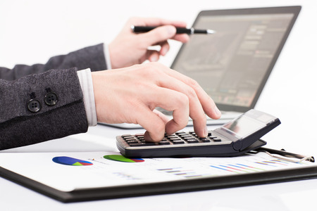 Businessman analyzing investment charts with laptop. Accountingの写真素材