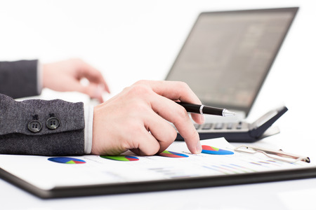 Businessman analyzing investment charts with laptop. Accountingの写真素材