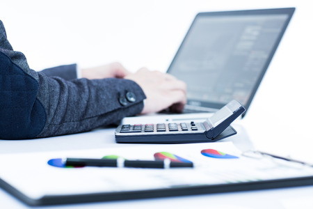 Businessman analyzing investment charts with laptop. Accountingの写真素材