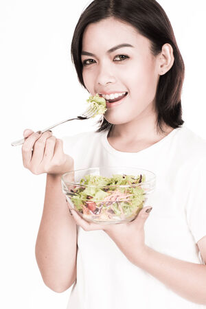 portrait of a lovely young woman eating healthyの写真素材