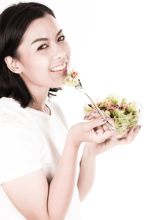 portrait of a lovely young woman eating healthyの写真素材