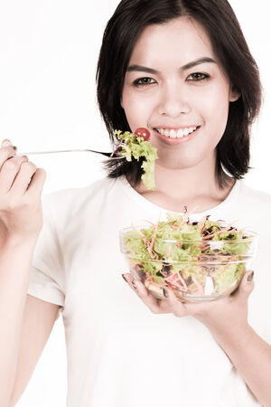 portrait of a lovely young woman eating healthyの写真素材