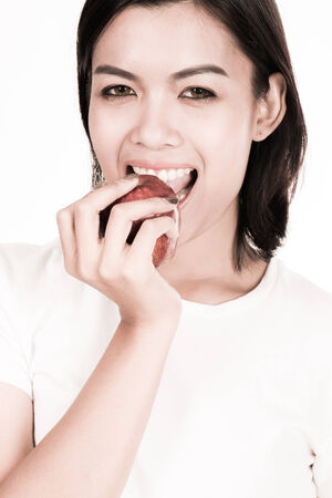portrait of a lovely young woman eating healthyの写真素材