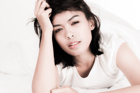 Portrait of a beautiful young woman in the bedの写真素材