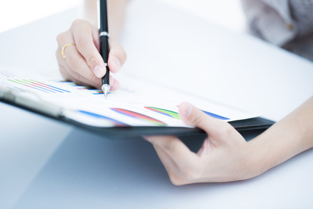 woman hand with pen and business report. Accountingの写真素材