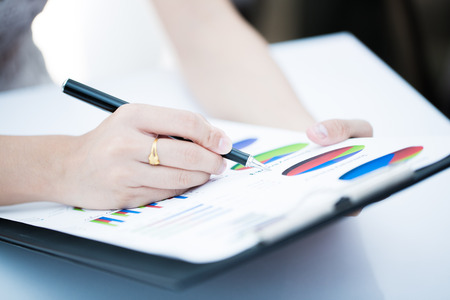 woman hand with pen and business report. Accountingの写真素材