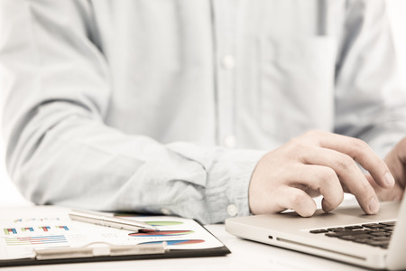 Businessman analyzing investment charts with laptop. Accountingの写真素材