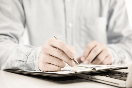 Businessman analyzing investment charts with laptop. Accountingの写真素材