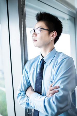 Portrait of a businessman looking at the window.Asianの写真素材