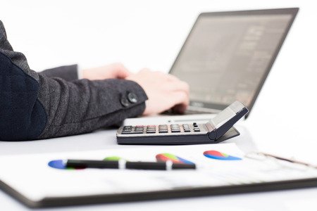 Businessman analyzing investment charts with laptop. Accountingの写真素材
