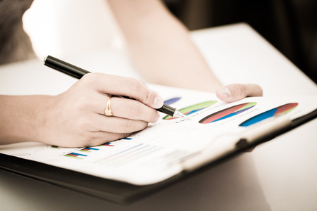 woman hand with pen and business report. Accountingの写真素材