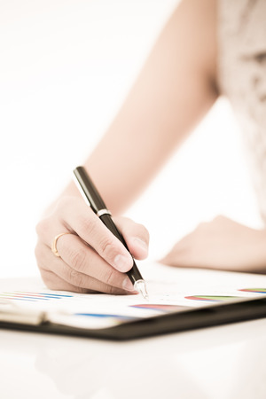 woman hand with pen and business report. Accountingの写真素材
