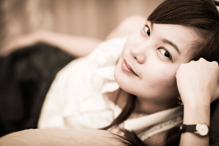 Portrait of a beautiful young woman in the bedの写真素材