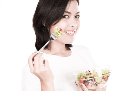 portrait of a lovely young woman eating healthyの写真素材
