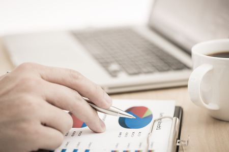 Businessman analyzing investment charts with laptop. Accountingの写真素材