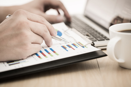 Businessman analyzing investment charts with laptop. Accountingの写真素材