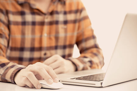 Happy man working on laptopの写真素材