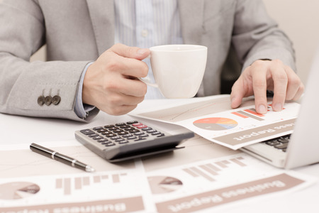 Businessman analyzing investment charts with laptop. Accountingの写真素材