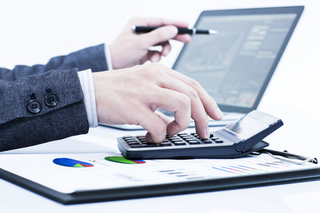Businessman analyzing investment charts with laptop. Accountingの写真素材